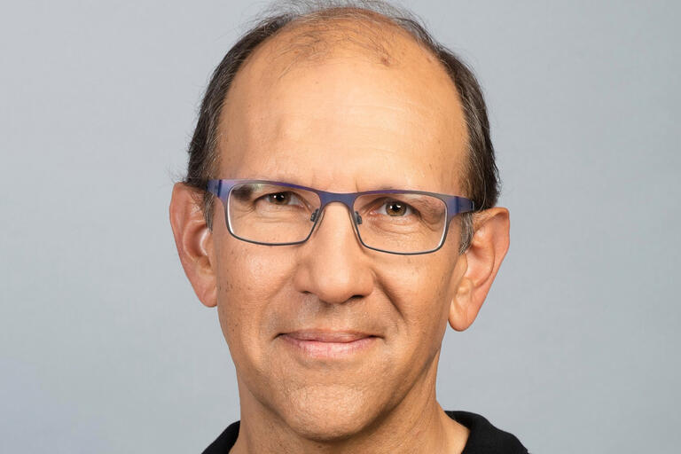 image of man in glasses smiling
