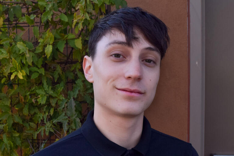 Headshot of man with blue shirt