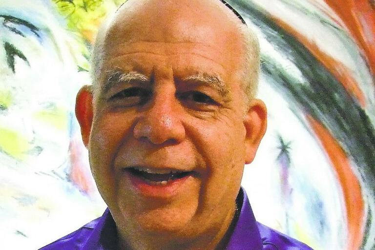 man in purple shirt smiling
