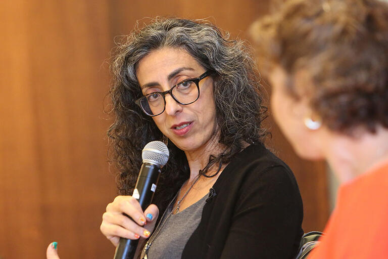 ayelet tsabari speaking into a microphone